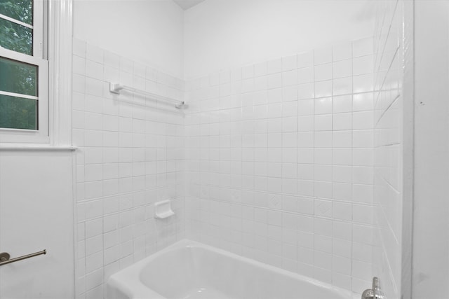 bathroom with washtub / shower combination