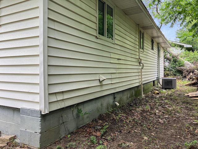 view of side of home featuring central AC