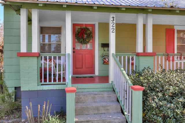 doorway to property featuring covered porch