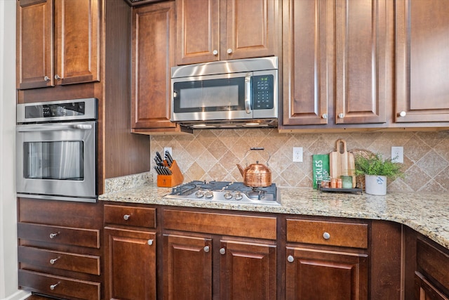 205 Langfuhr Way, North Augusta, SC 29860 - kitchen with stainless steel appliances, backsplash, and light stone counters