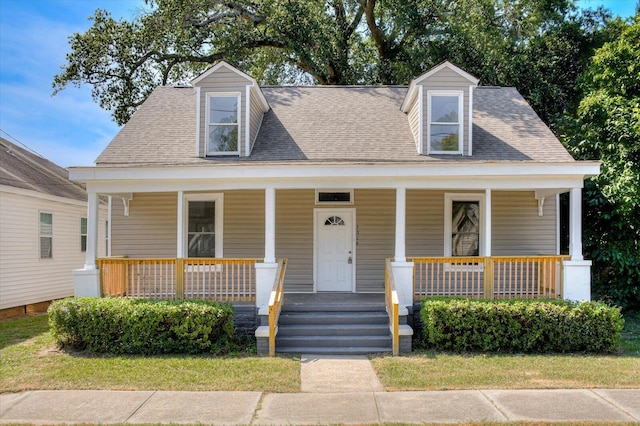 cape cod house featuring a porch