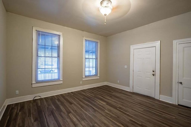 empty room with dark hardwood / wood-style floors