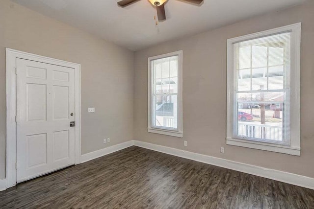 spare room featuring ceiling fan and dark wood-type flooring