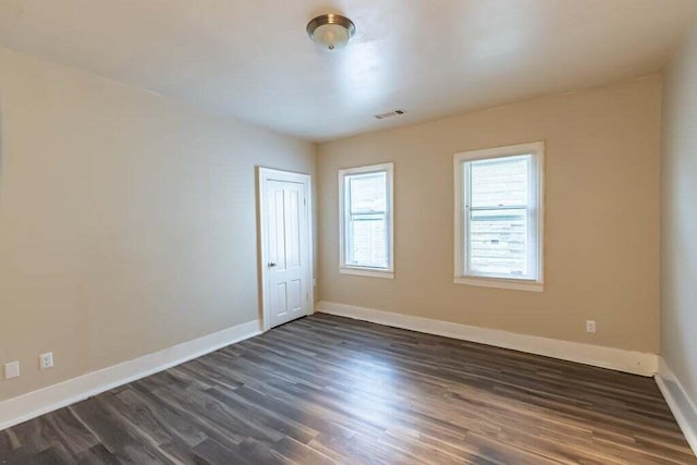 unfurnished room with dark hardwood / wood-style floors