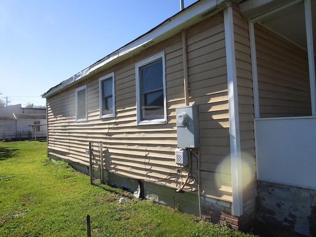 view of side of home featuring a yard