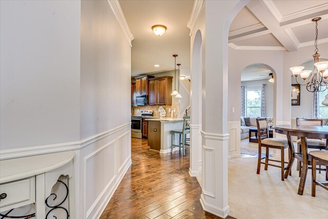 3374 Grove Landing Cir, Grovetown, GA 30813 - corridor featuring arched walkways, ornamental molding, light wood-style floors, a decorative wall, and beam ceiling