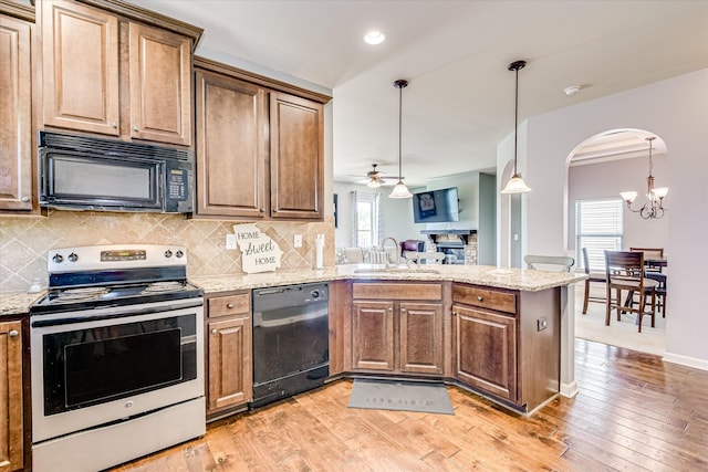 3374 Grove Landing Cir, Grovetown, GA 30813 - kitchen with black appliances, a sink, arched walkways, a peninsula, and a ceiling fan