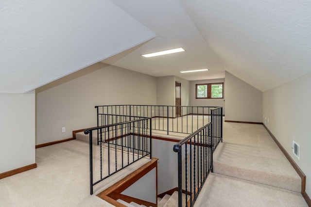 705 Woodgate Ct, Augusta, GA 30909 - stairs featuring carpet flooring, vaulted ceiling, and a textured ceiling