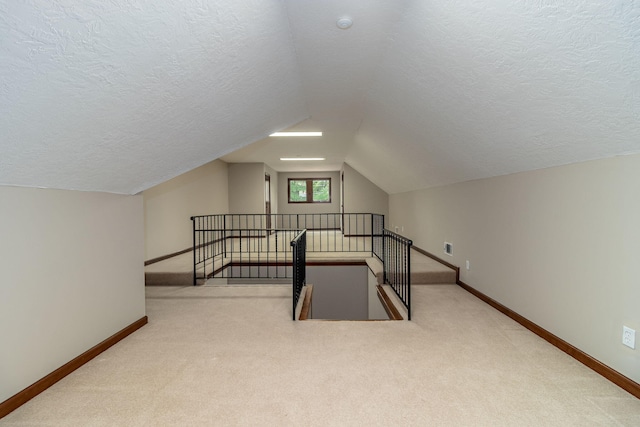 705 Woodgate Ct, Augusta, GA 30909 - bonus room featuring a textured ceiling, carpet flooring, and lofted ceiling