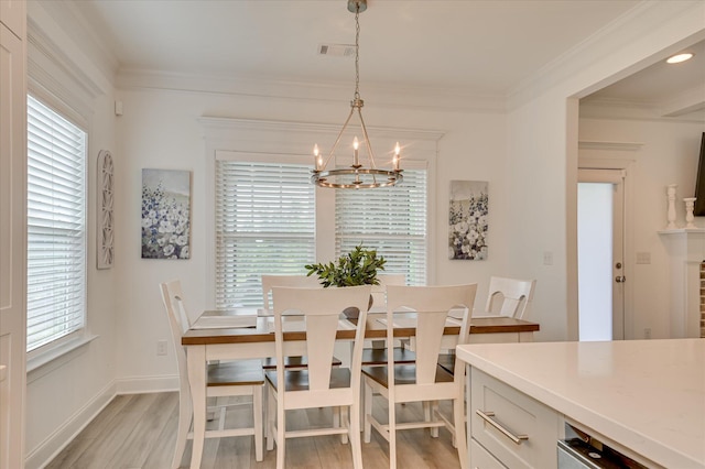 508 Oakley Grv Cir, Evans, GA 30809 - dining room featuring a chandelier, light wood finished floors, and crown molding