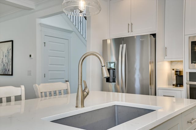 508 Oakley Grv Cir, Evans, GA 30809 - kitchen with stainless steel refrigerator with ice dispenser, white cabinets, crown molding, light stone counters, and decorative light fixtures