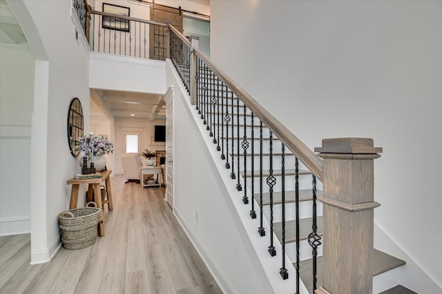 508 Oakley Grv Cir, Evans, GA 30809 - stairs featuring wood finished floors, arched walkways, and a high ceiling