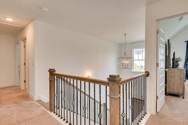 508 Oakley Grv Cir, Evans, GA 30809 - hallway featuring carpet floors, attic access, an upstairs landing, and a chandelier