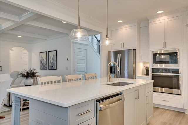 508 Oakley Grv Cir, Evans, GA 30809 - kitchen featuring appliances with stainless steel finishes, light wood-style floors, open floor plan, recessed lighting, and arched walkways