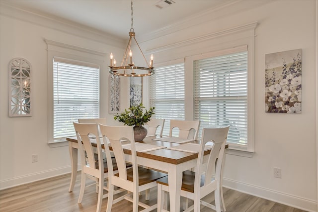 508 Oakley Grv Cir, Evans, GA 30809 - dining room with a chandelier, plenty of natural light, crown molding, and light wood-type flooring