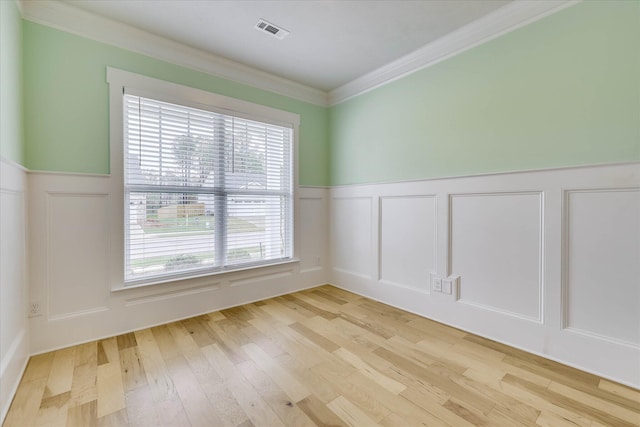 6135 Mottled Duck Dr, North Augusta, SC 29860 - unfurnished room with a decorative wall, wainscoting, plenty of natural light, light wood-style flooring, and crown molding