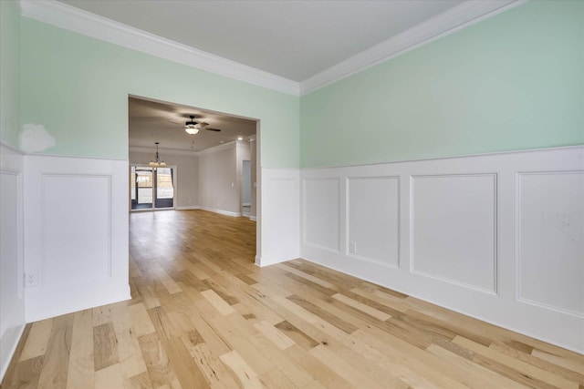6135 Mottled Duck Dr, North Augusta, SC 29860 - unfurnished room featuring ornamental molding, a decorative wall, light wood-type flooring, a chandelier, and a wainscoted wall