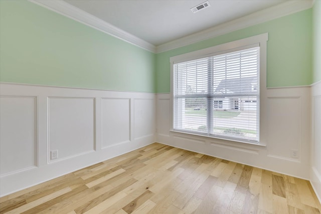 6135 Mottled Duck Dr, North Augusta, SC 29860 - unfurnished room featuring ornamental molding, a decorative wall, wainscoting, and light wood finished floors