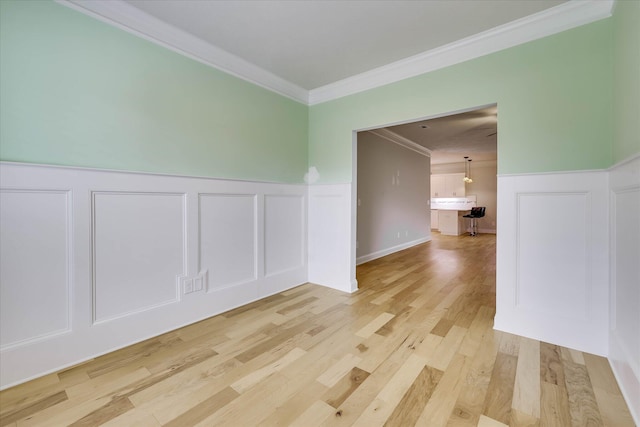 6135 Mottled Duck Dr, North Augusta, SC 29860 - unfurnished room featuring a decorative wall, crown molding, light wood-style flooring, and a wainscoted wall