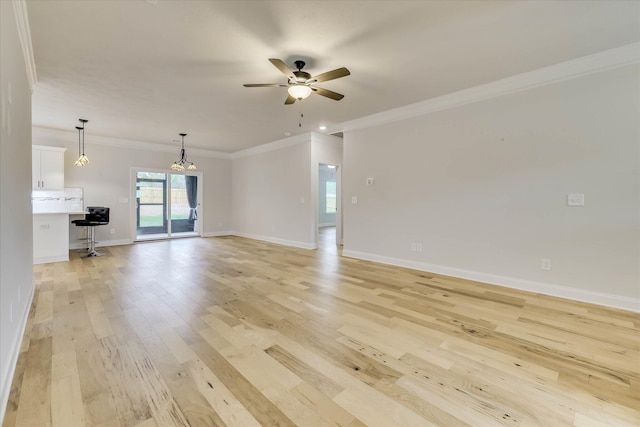 6135 Mottled Duck Dr, North Augusta, SC 29860 - unfurnished living room featuring a ceiling fan, light wood-style flooring, a chandelier, baseboards, and ornamental molding