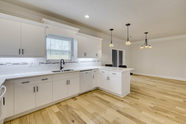 6135 Mottled Duck Dr, North Augusta, SC 29860 - kitchen with dishwasher, a sink, ornamental molding, backsplash, and a peninsula