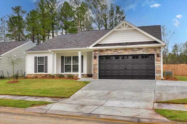 6135 Mottled Duck Dr, North Augusta, SC 29860 - view of front of home featuring stone siding, concrete driveway, a garage, and roof with shingles