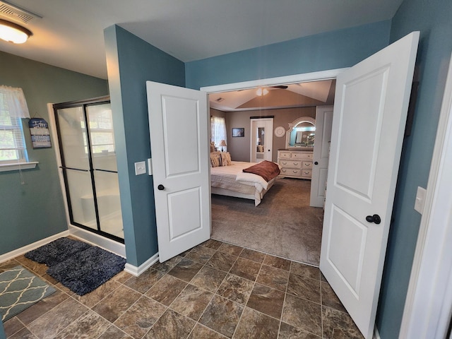 bathroom with visible vents, baseboards, a stall shower, ensuite bathroom, and stone finish floor