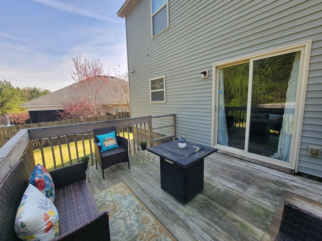 wooden terrace featuring fence