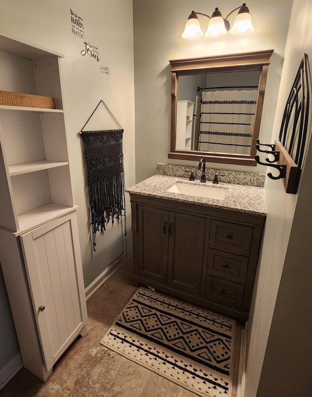 bathroom featuring baseboards and vanity