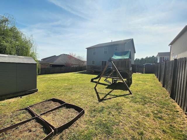 view of yard with a playground, an outbuilding, a fenced backyard, and a shed