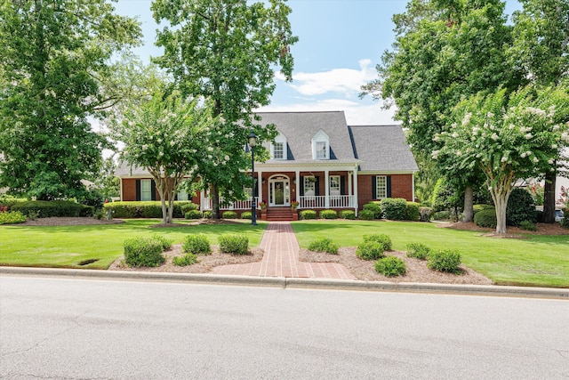 3570 Granite Way, Martinez, GA 30907 - new england style home featuring a porch, a front lawn, and brick siding