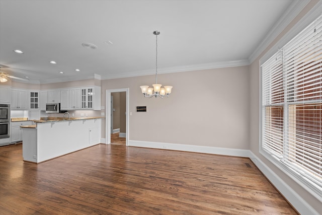 3570 Granite Way, Martinez, GA 30907 - kitchen with a chandelier, appliances with stainless steel finishes, healthy amount of natural light, a breakfast bar area, and crown molding