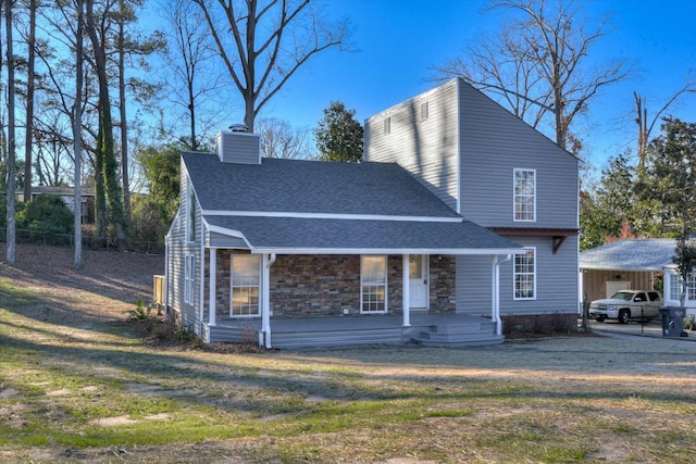 view of front of home featuring covered porch and a front yard