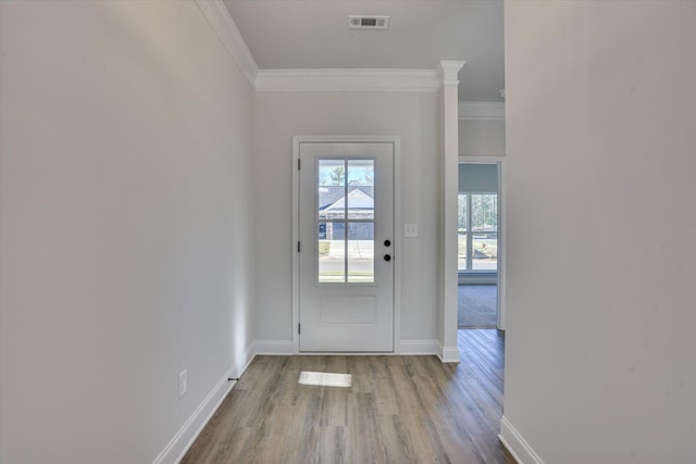 entryway featuring light wood-type flooring and crown molding