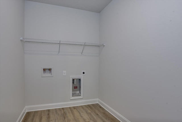 laundry area featuring hookup for an electric dryer, washer hookup, and light hardwood / wood-style flooring