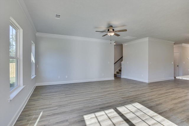 spare room featuring crown molding, ceiling fan, and light wood-type flooring