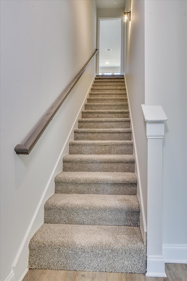 staircase featuring wood-type flooring