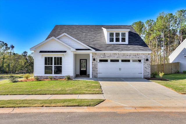 view of front of property with a garage and a front lawn