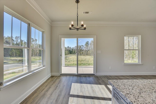 unfurnished dining area featuring ornamental molding, dark hardwood / wood-style floors, and a notable chandelier