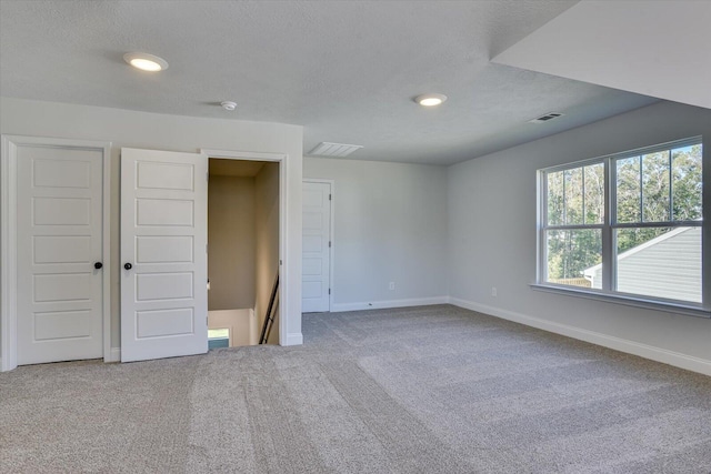 unfurnished bedroom featuring carpet floors and a textured ceiling