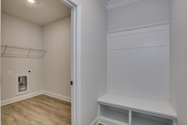 washroom featuring hookup for an electric dryer, light hardwood / wood-style flooring, and ornamental molding