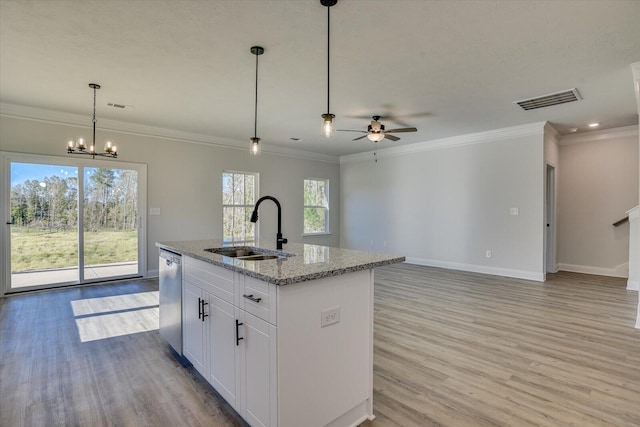 kitchen featuring white cabinetry, sink, light stone countertops, stainless steel dishwasher, and an island with sink