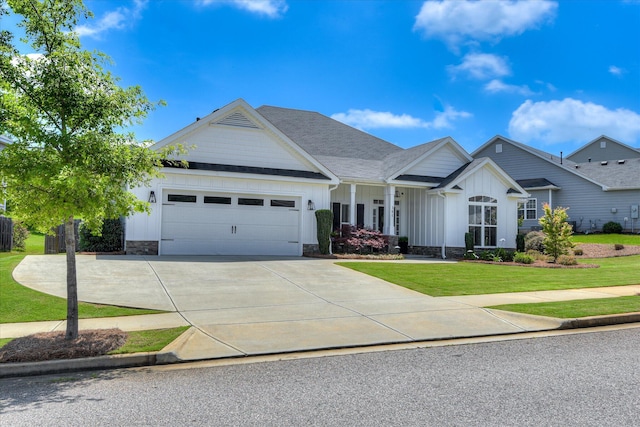 385 Bridle Path Rd, North Augusta, SC 29860 - view of front of house featuring board and batten siding, an attached garage, a front lawn, driveway, and a shingled roof