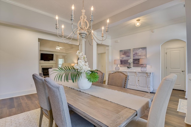385 Bridle Path Rd, North Augusta, SC 29860 - dining area featuring ornamental molding, wood finished floors, a chandelier, ceiling fan, and a fireplace