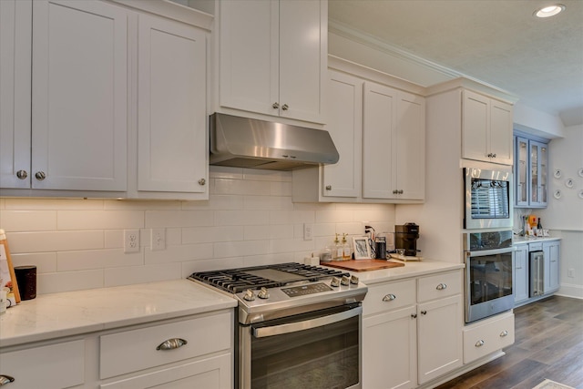 385 Bridle Path Rd, North Augusta, SC 29860 - kitchen featuring stainless steel gas range, under cabinet range hood, dark wood-style flooring, tasteful backsplash, and recessed lighting