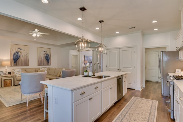 385 Bridle Path Rd, North Augusta, SC 29860 - kitchen featuring stainless steel appliances, white cabinets, a kitchen island with sink, dark wood-style flooring, and crown molding