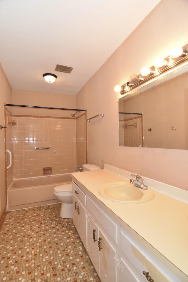 full bath featuring visible vents, washtub / shower combination, vanity, and toilet