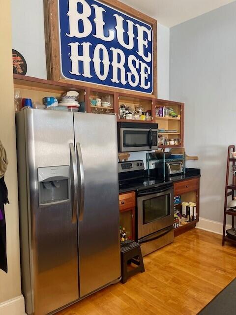 kitchen featuring stainless steel appliances and light hardwood / wood-style floors