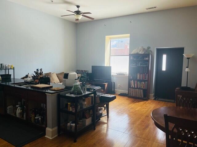 living room with ceiling fan and hardwood / wood-style floors