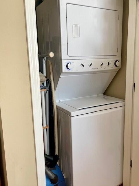 laundry room featuring stacked washing maching and dryer